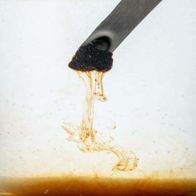 Shilajit dissolving from a spoon
