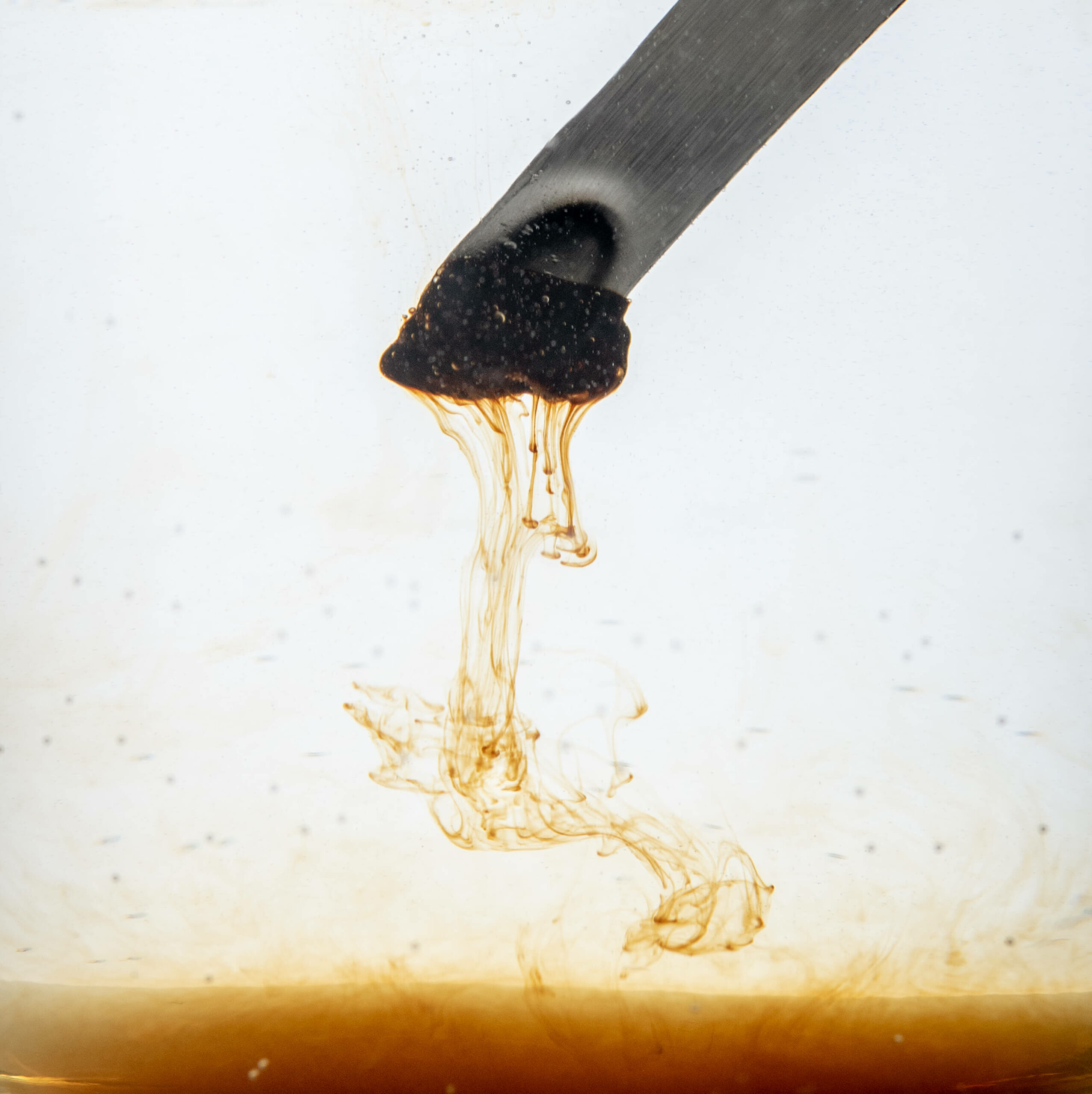 Shilajit dissolving from a spoon